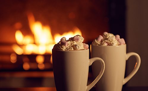 Hot chocolates in front of a fire