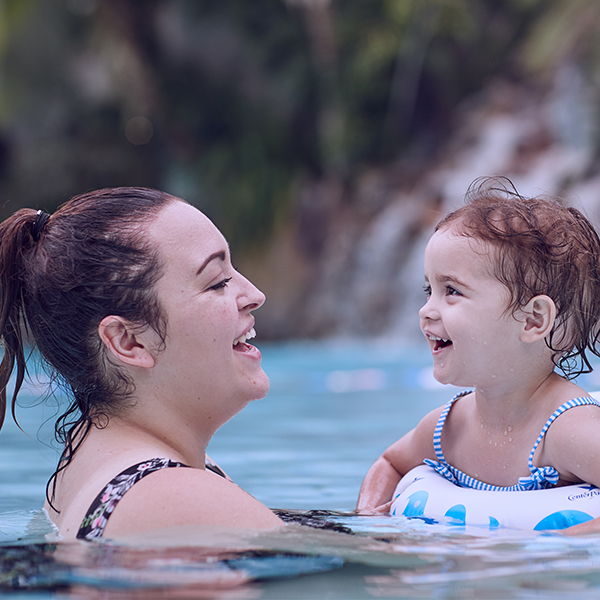 Mother and child playing in the pool