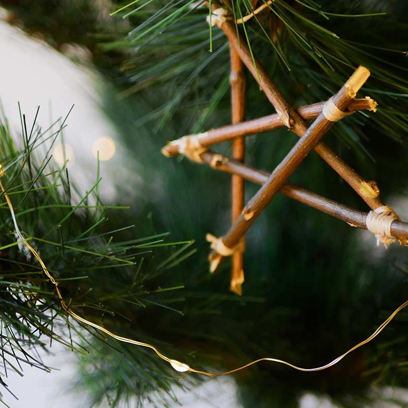 handmade Christmas tree decorations, a star made out of twigs and a dried orange slice 