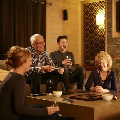 Family playing board game in lodge