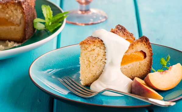 Peach and almond cake slice with cream