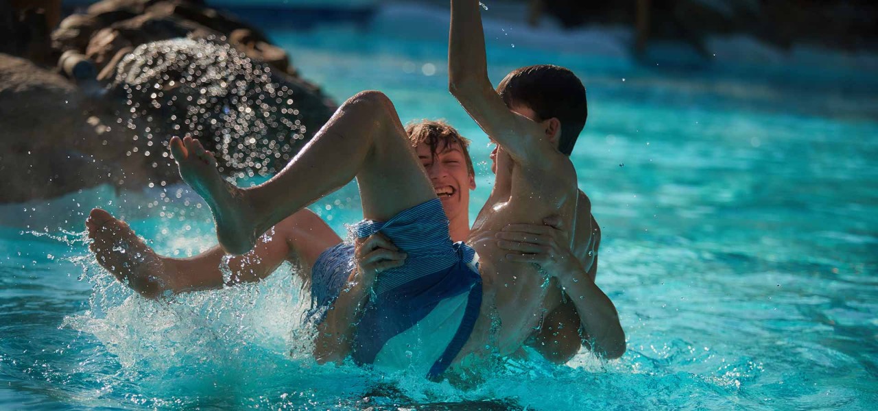 two teenagers laugh as they play in the Subtropical Swimming Paradise
