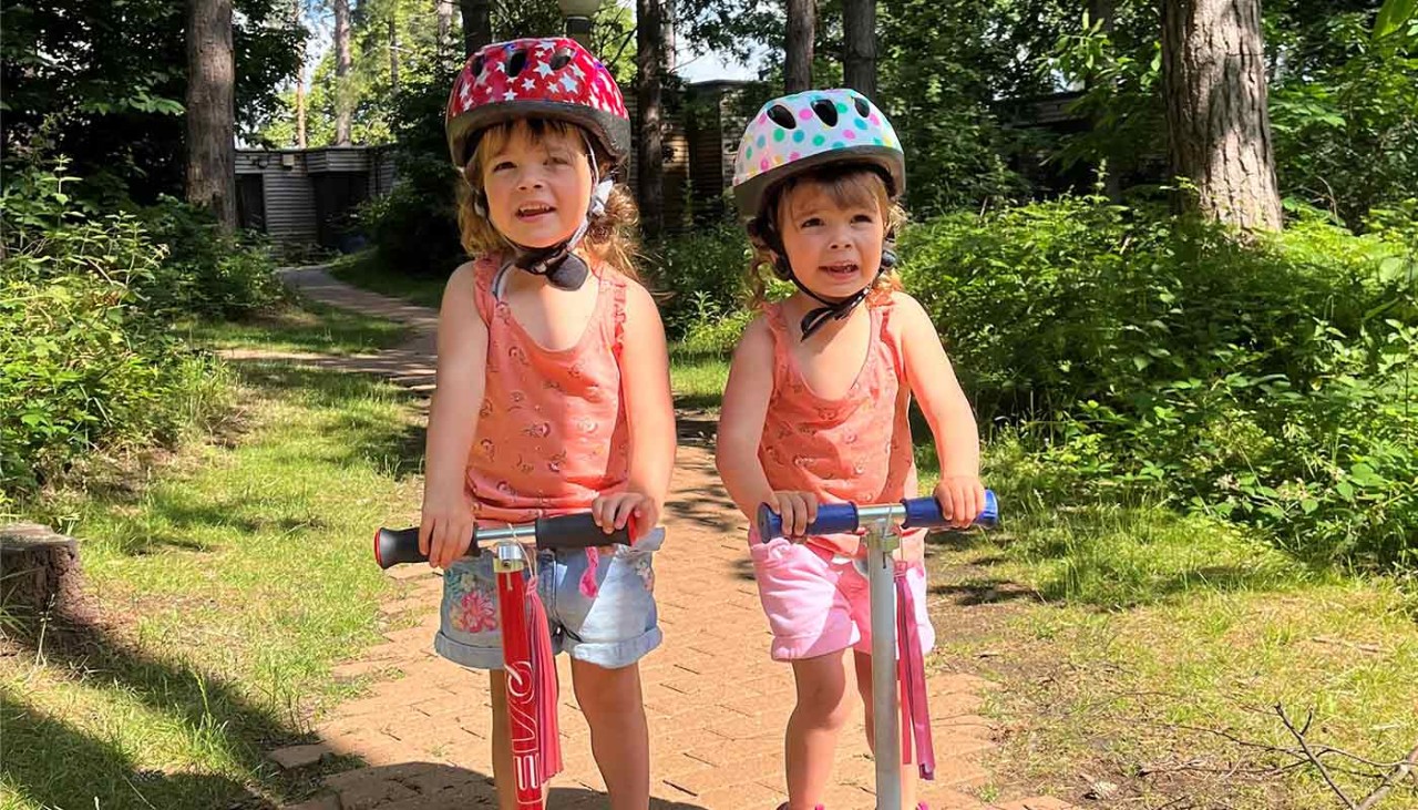 Two little girls on scooters