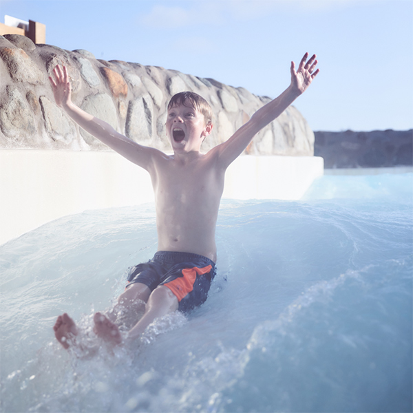 A boy on the outdoor rapids in the Subtropical Swimming Paradise.