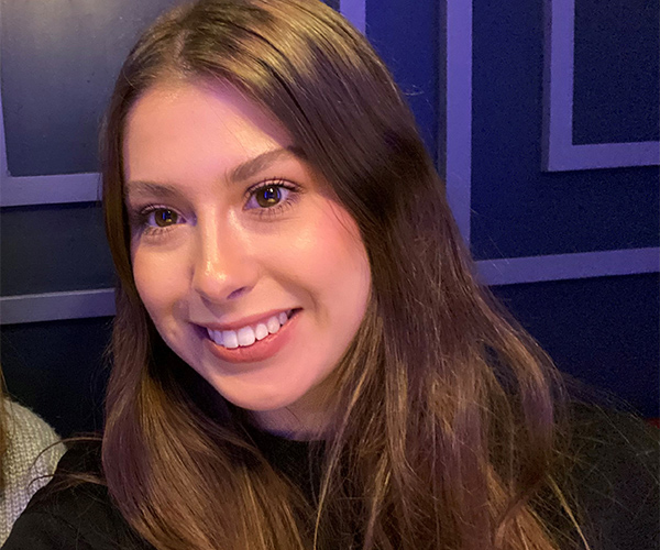 Marketing Assistant Alex smiling at camera.