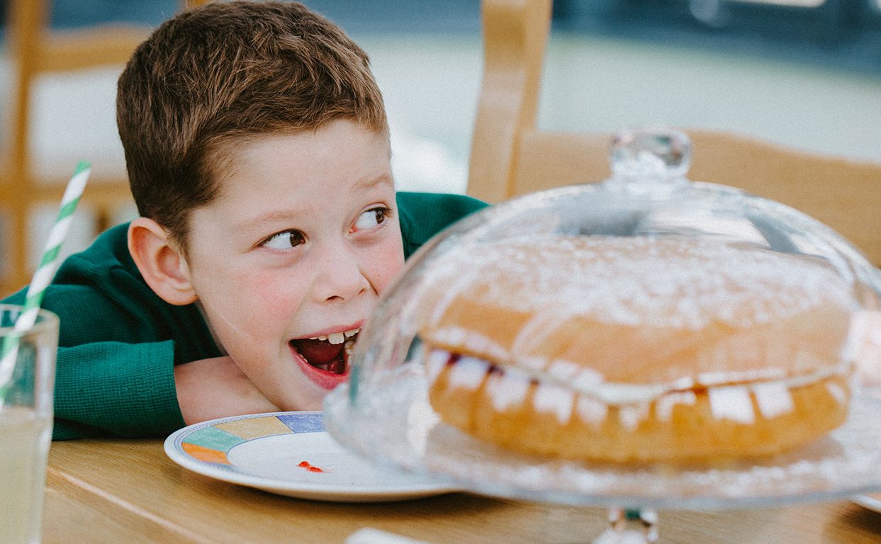 Young boy, Nicholas, staring with wide eyes and mouth open at a cake