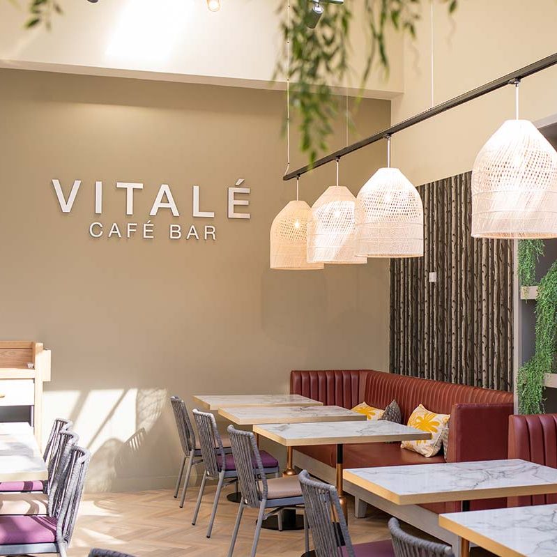 Vitale Cafe Bar, with bench seating and forest wallpaper