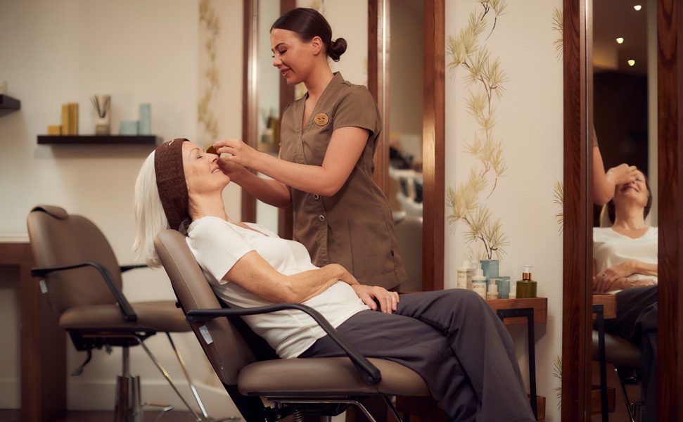 therapist performing eye treatment in express area