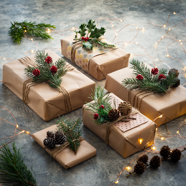 Gifts decorated with pine cones and holly
