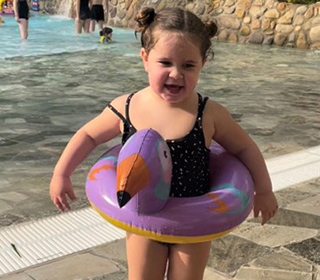 little-girl-in-inflatable-next-to-swimming-pool