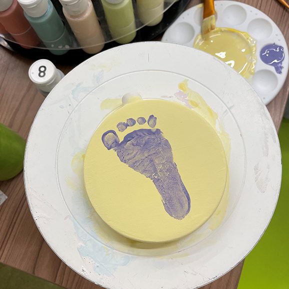 Wilf's footprint in purple paint at the Pottery Painting activity