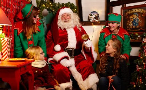 Two girls meeting Santa and his two elves