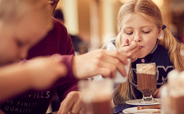 Girl enjoys hot chocolate at the Pancake House