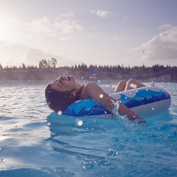 Child on a lilo in the pool