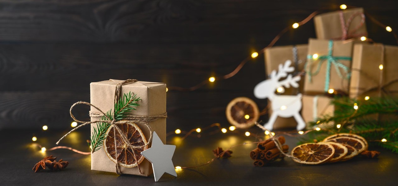 A selection of brown paper wrapped presents with dried orange slice decoration