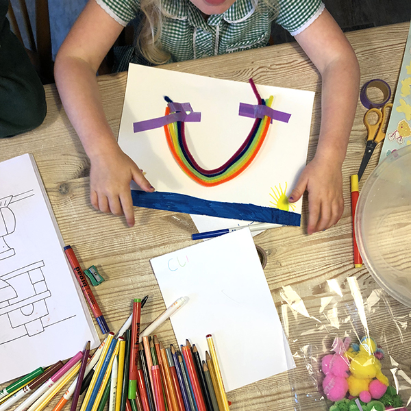 Child creates rainbow using arts and crafts