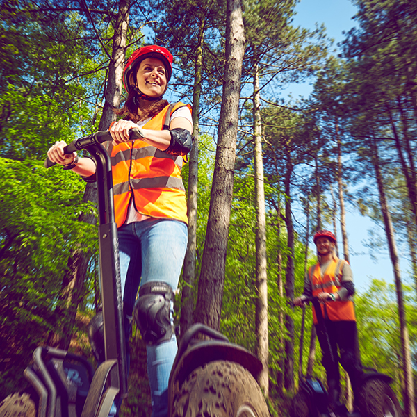 Pair on Segways through the forest