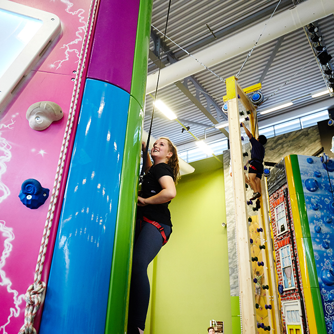 Girl climbing indoor climbing wall
