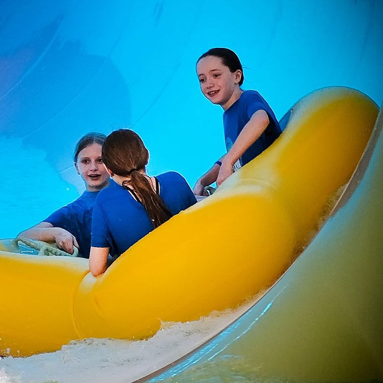 Children smile as they ride the Tropical Cyclone