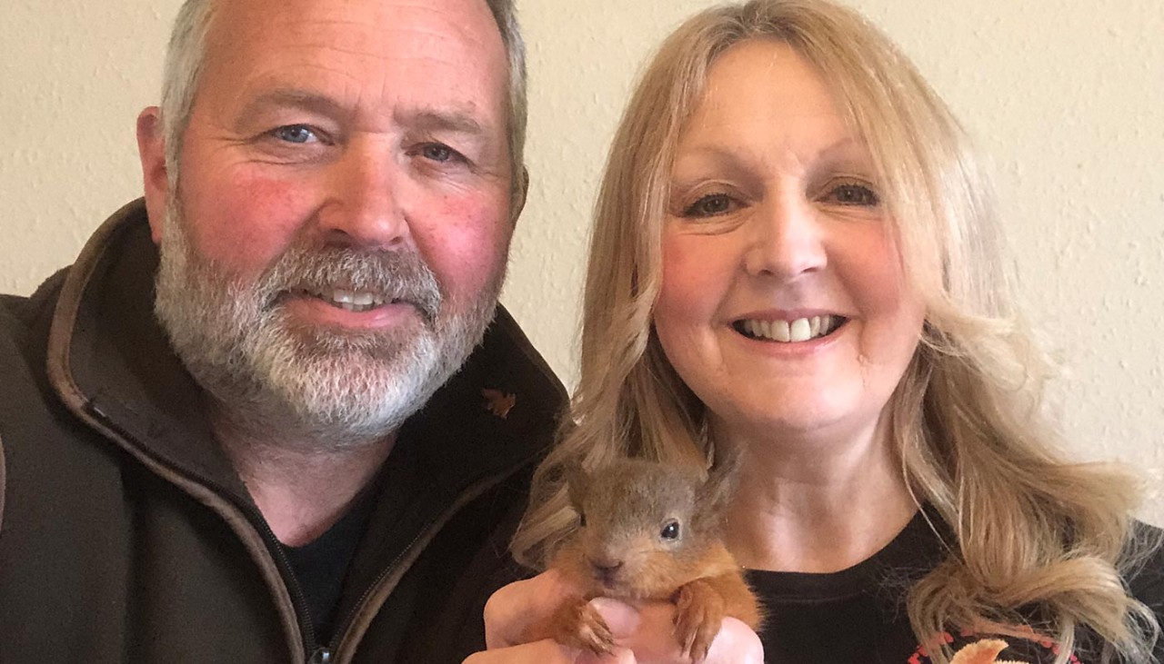 Jerry and wife holding Oscar the red squirrel 