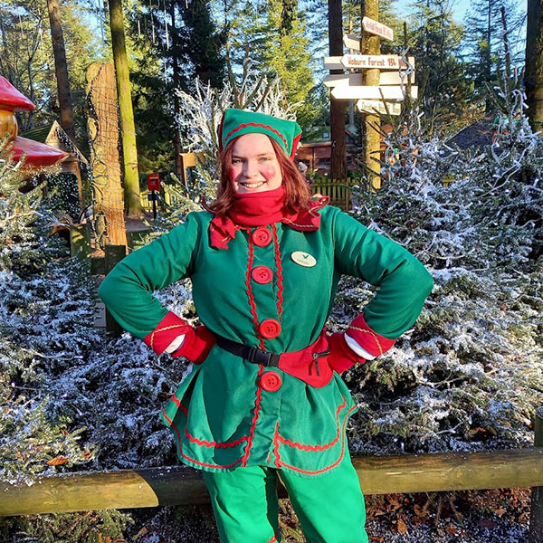 Giggles the elf stood in Santa's Woodland Village