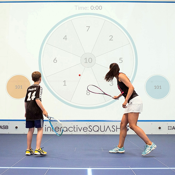 A pair playing interactive squash.