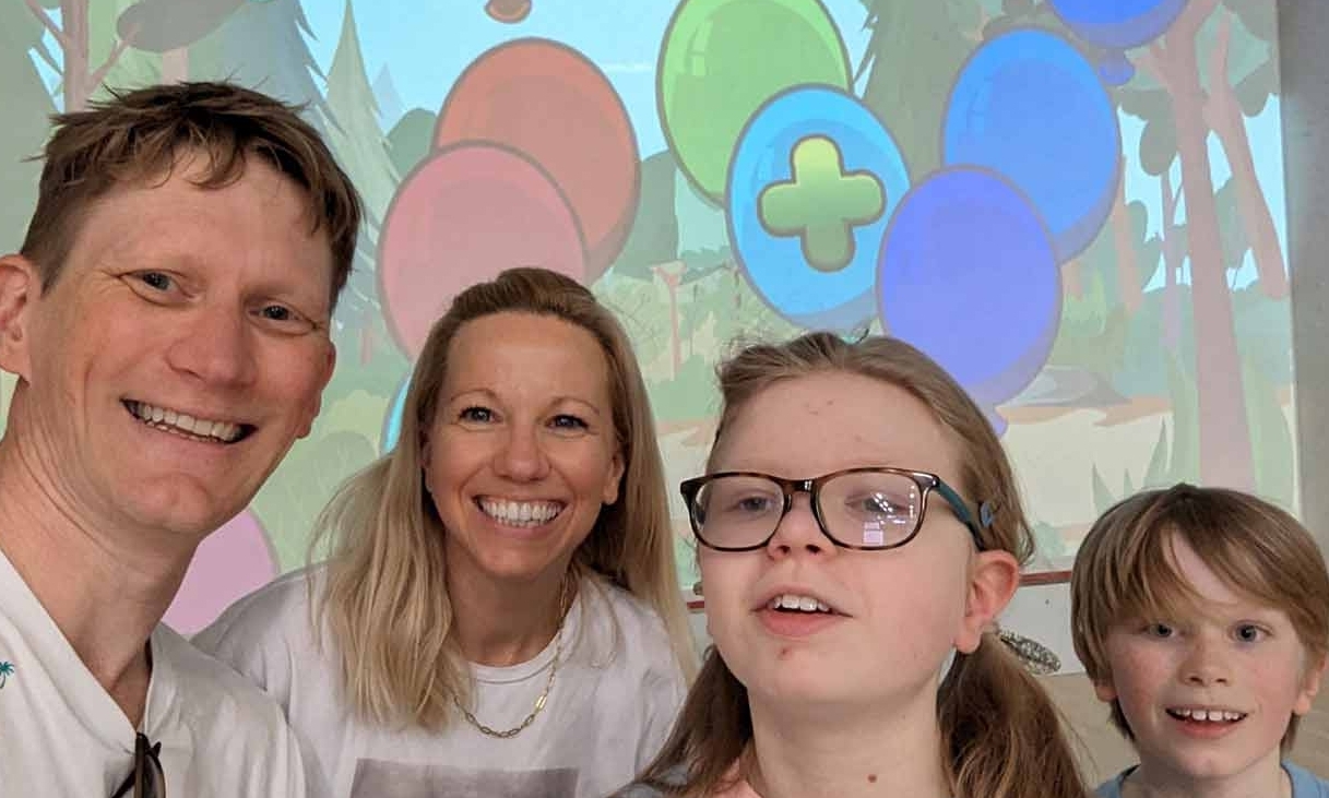 Orla and her family smile together in Family Ball Wall