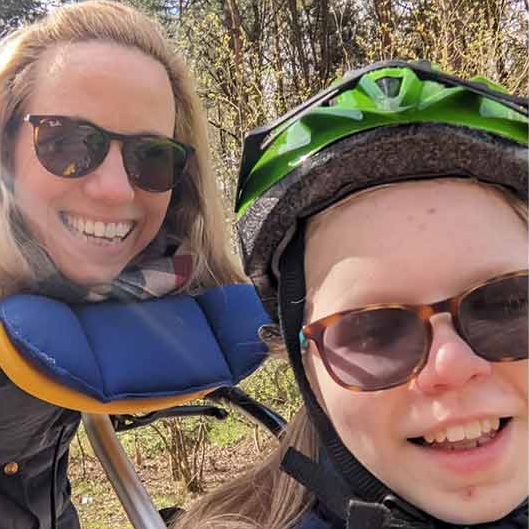 A selfie of Orla and her mum wearing bicycle helmets