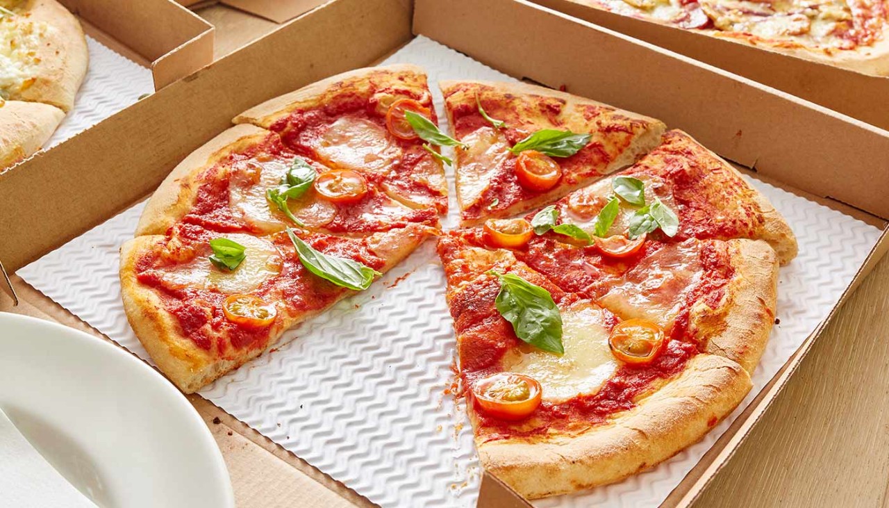 A takeaway pizza in a cardboard box