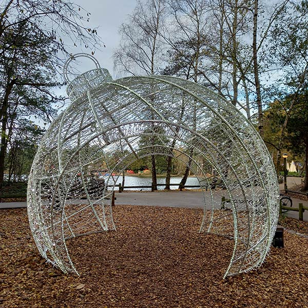 giant light up Christmas bauble arch with lake view backdrop 