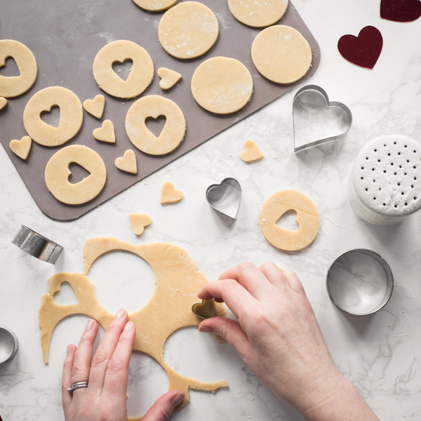 Cut outs of valentines biscuits from dough