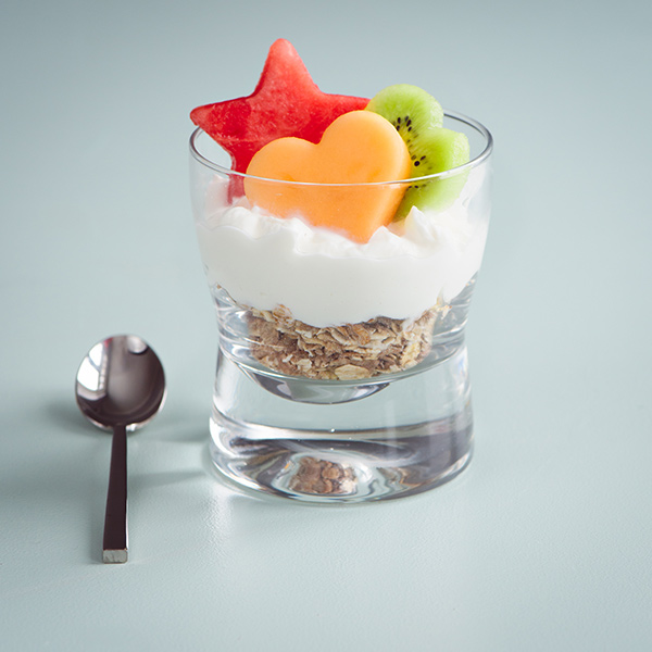 Granola, yogurt and fruit filled glass