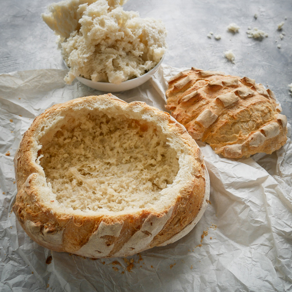 A crusty loaf of bread which has been hollowed out, turning it into a bread bowl 