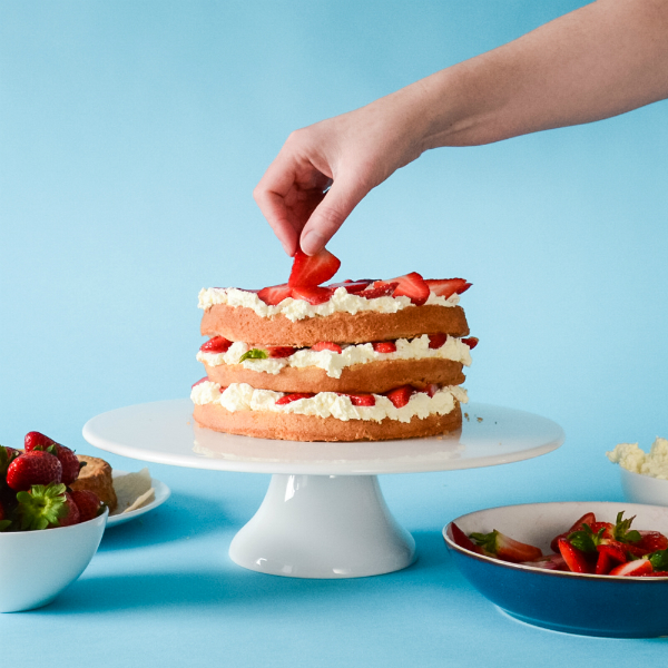 Decorating the Strawberry layer cake with fruit