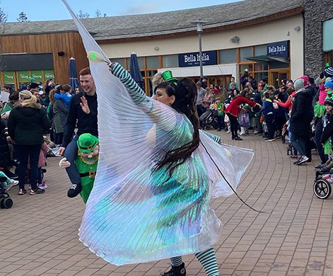 A performer with wings, entertaining in the St Patricks Day parade