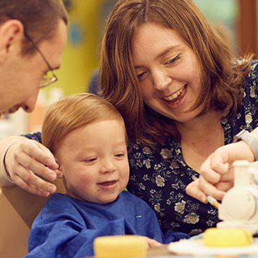 Family enjoy pottery painting