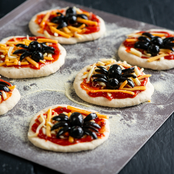 Mini pizzas with spiders on