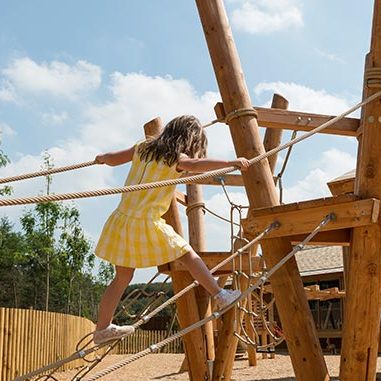 Girl crossing rope bridge