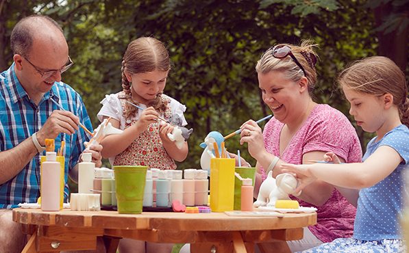 Family pottery painting outdoors