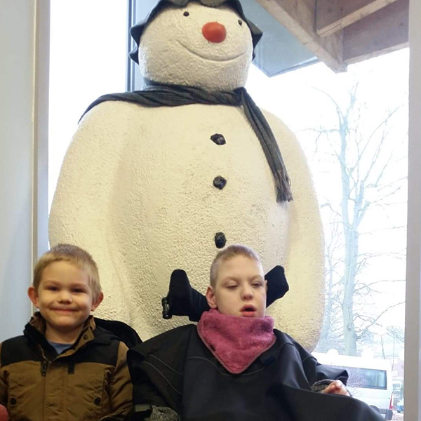 Tom in his wheelchair in front of The Snowman.