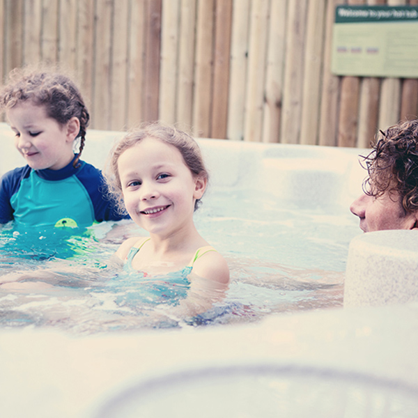 A family relaxing in a hot tub.