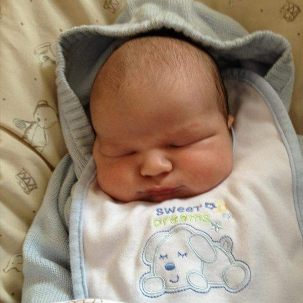 baby-boy-sleeping-in-blue-knitted-jumper