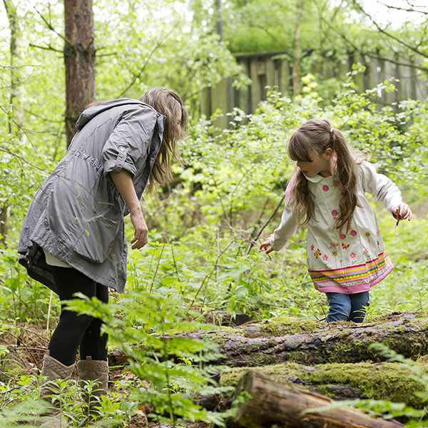 Mother and daughter exploring the forest
