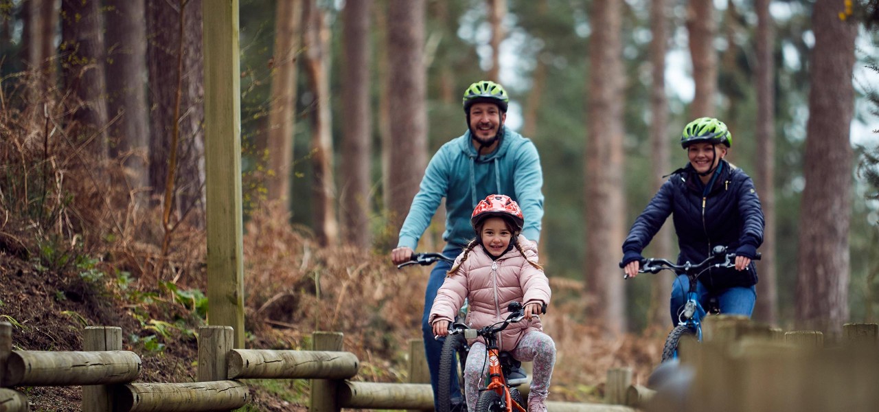 Family cycling through woods