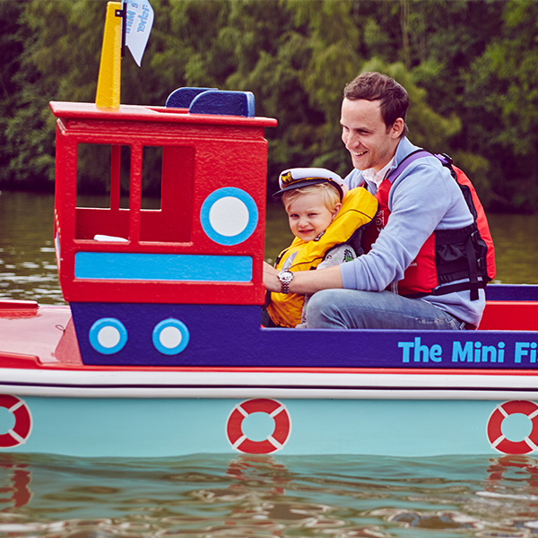 Father and child on Mini Captain's Adventure boat