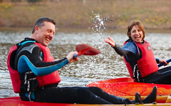 Woman splashes partner on Kayak