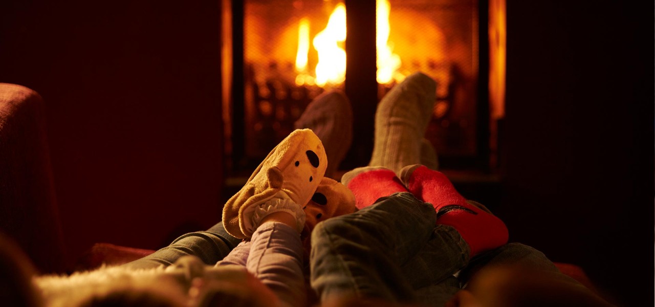 Family warm feet by the open fire